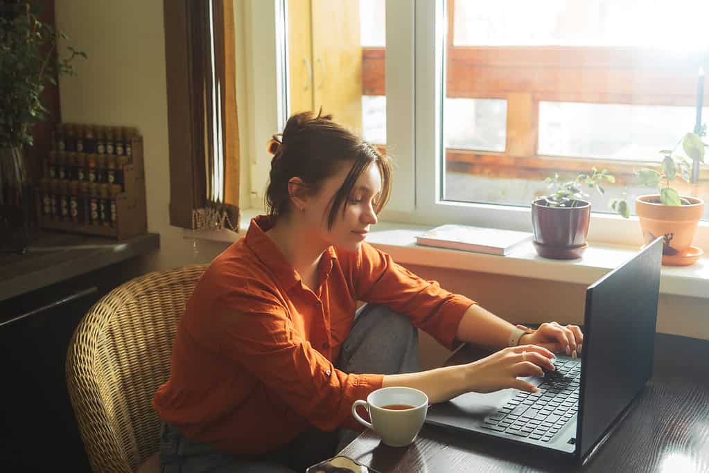 woman blogging on her laptop earning income