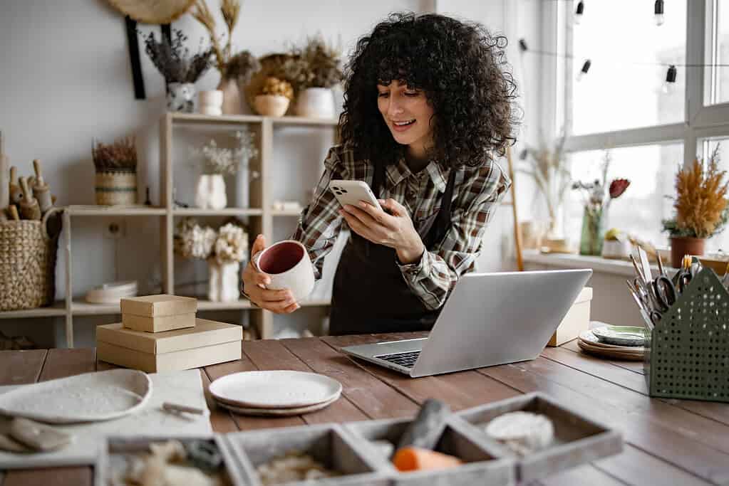 side hustle at home with a girl taking images of her stock for selling