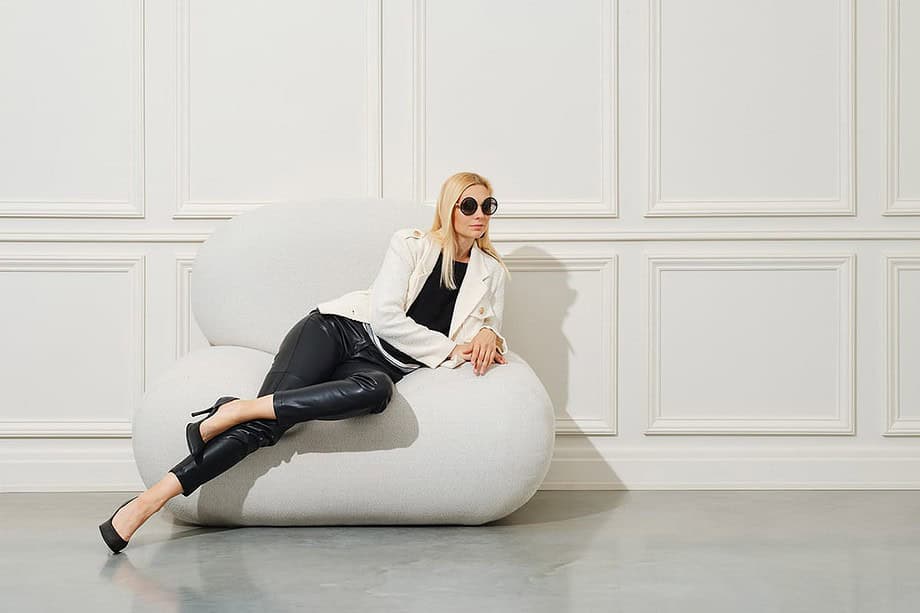 a woman lying on a sofa in a Minimalist Lifestyle