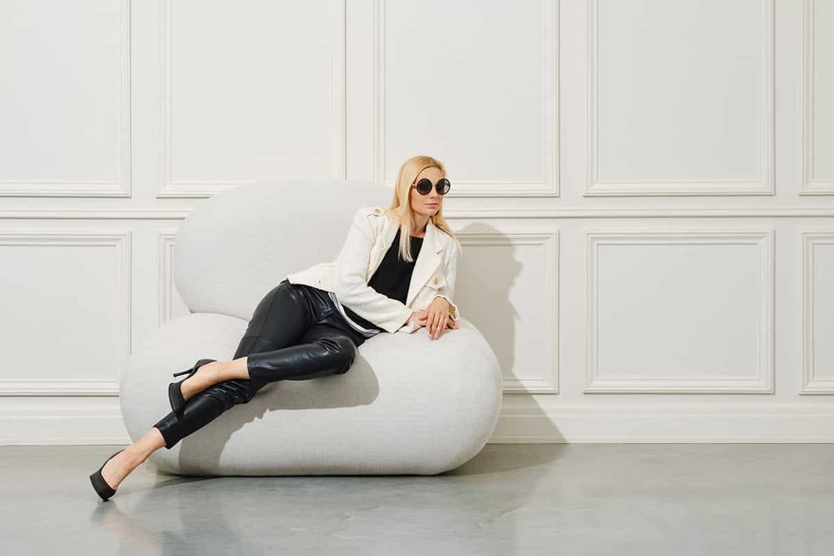 a woman lying on a sofa in a Minimalist Lifestyle