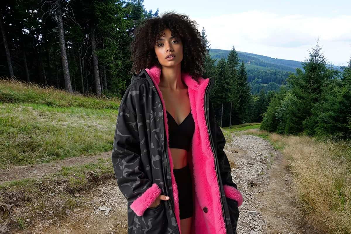 A woman wearing a Dryrobe Advance Long Sleeve outdoors