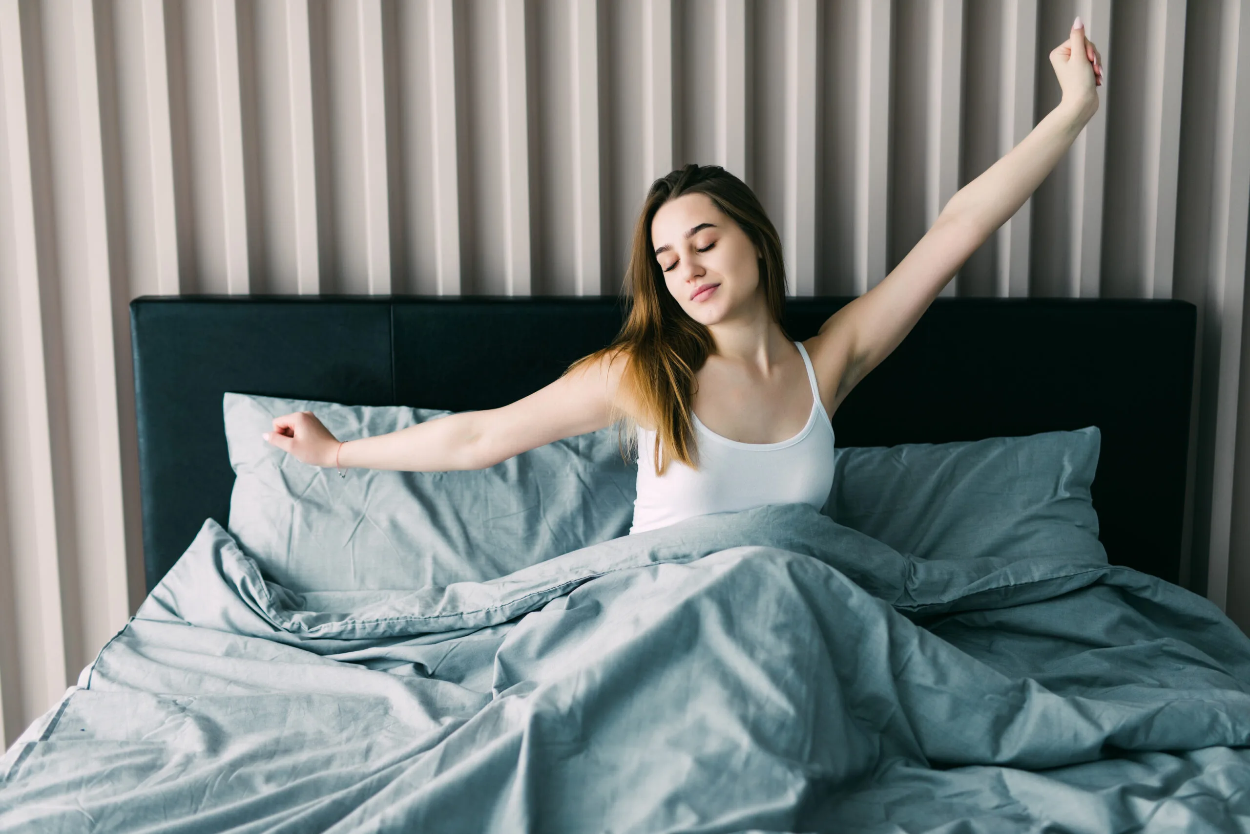 morning routines 2025 woman waking up in bed in the morning