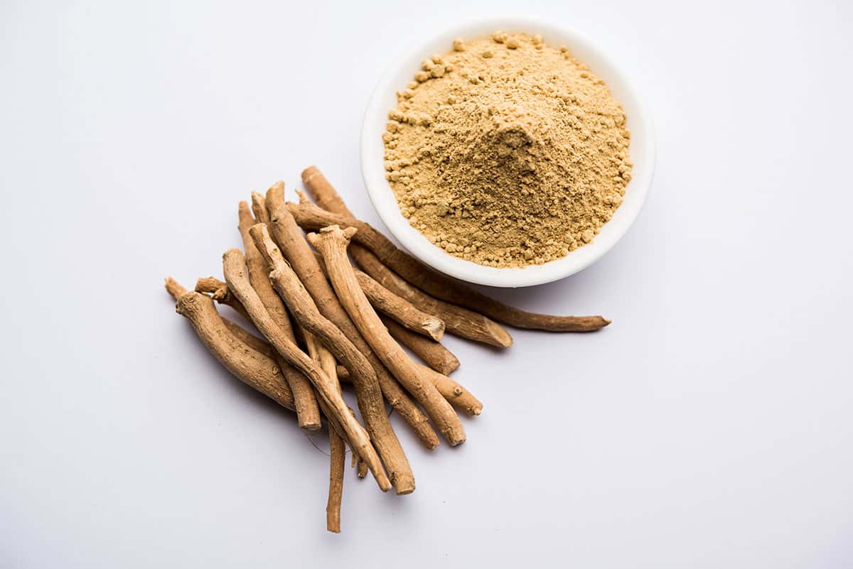ashwagandha-aswaganda-indian-ginseng-is-ayurveda-medicine-stem-powder-form-isolated-plain-background-selective-focus Some product herb on a white background promoting ashwagandha benefits