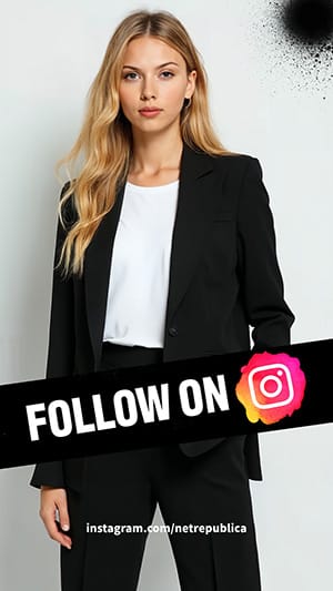 a womn wearing a black suit and white t-shirt, white background